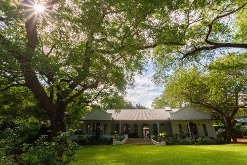 Lodge garden, lawn and exterior at The Courtney Lodge, Victoria Falls