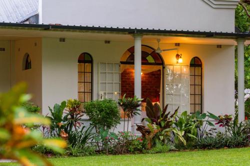 The verandah and flowerbeds at The Courtney Lodge, Victoria Falls