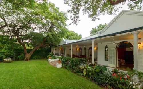 Verandah and garden at The Courtney Lodge, Victoria Falls