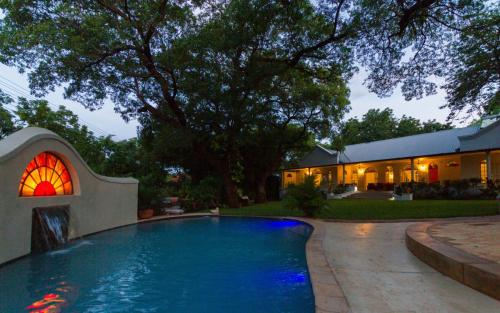 The pool at night at The Courtney Lodge, Victoria Falls