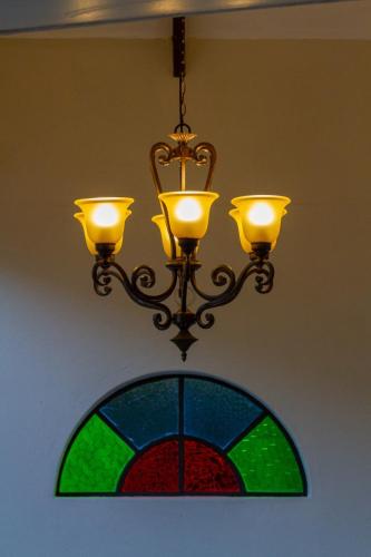 Chandelier and stained glass details at The Courtney Lodge, Victoria Falls