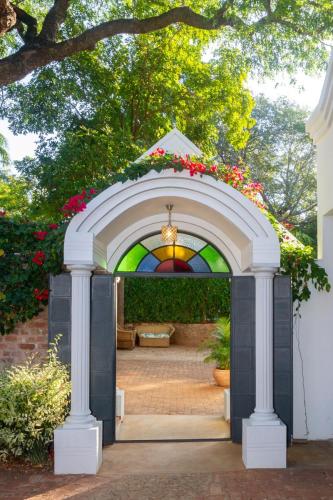 Arched courtyard entrance at The Courtney Lodge, Victoria Falls